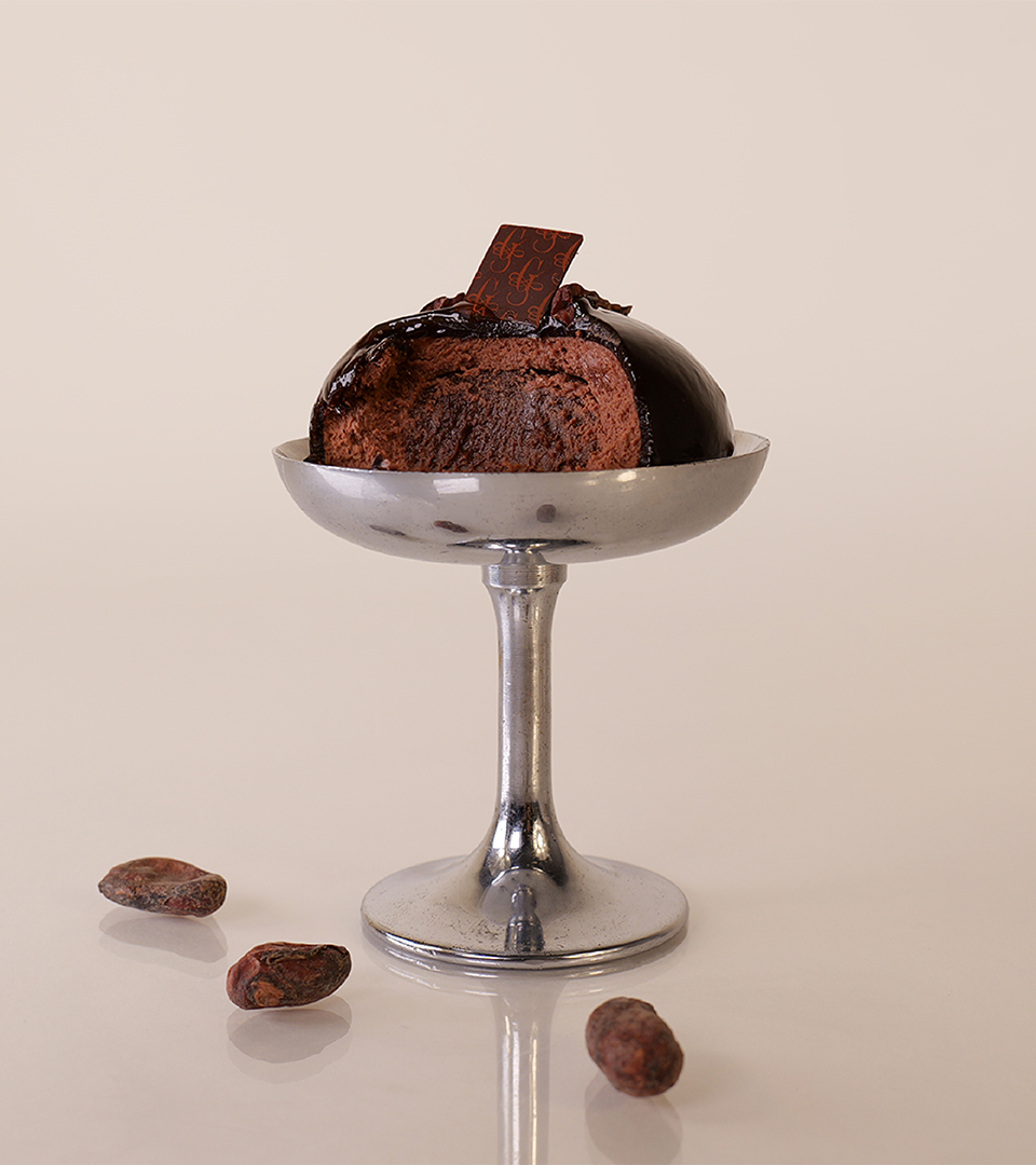 Monoporzione al cioccolato fondente con fave di cacao, luce controllata e styling essenziale vista mobile