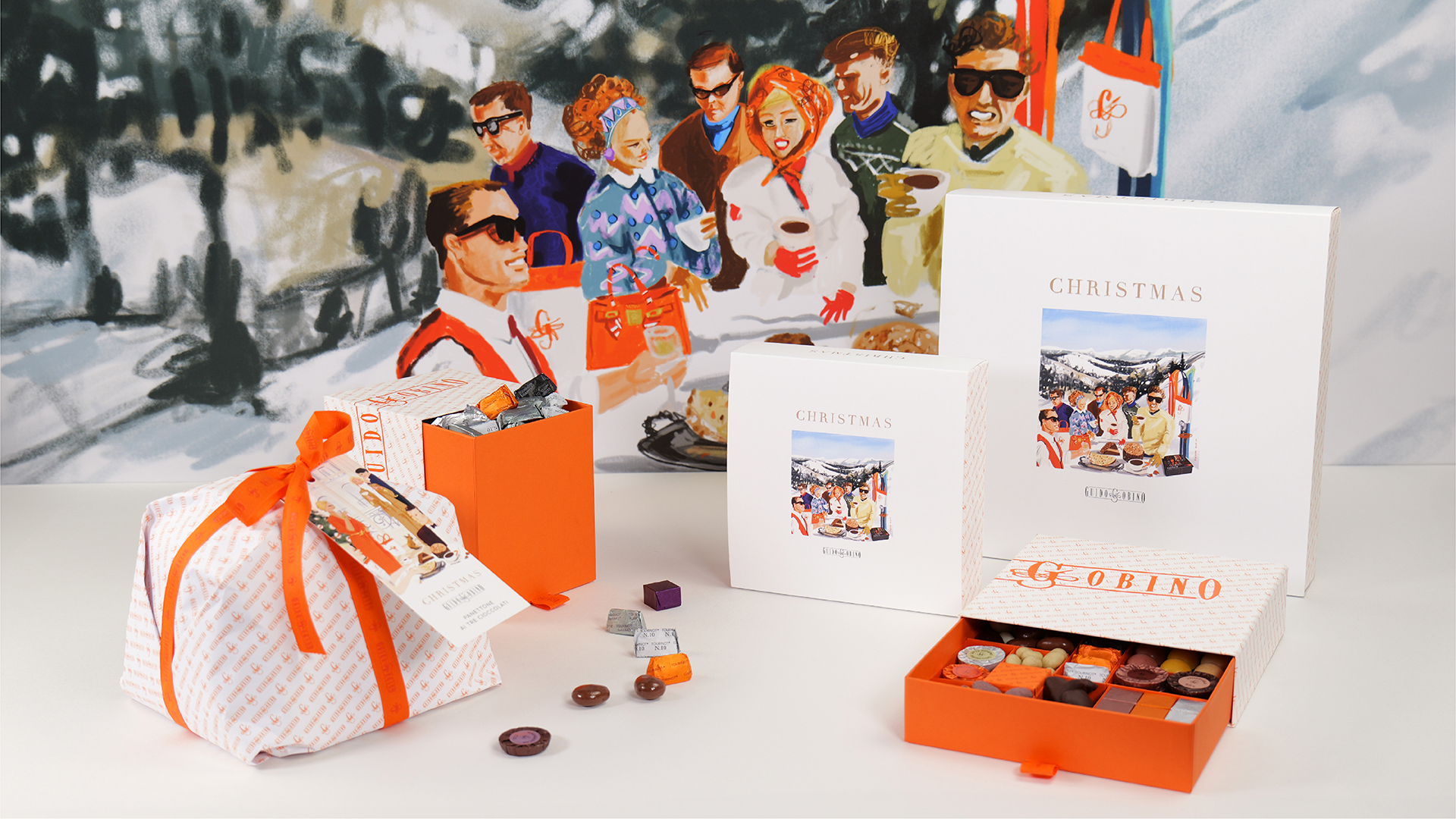 Composizione prodotti Christmas Collection 2024 con illustrazione alpina sullo sfondo
